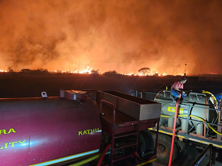 More than 50 vehicles from NGOs and the farming community helping to extinguish the veld fire.