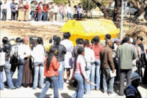 SHOCKED: Students take time off to mill around a rubbish bin where yet another foetus was found at the University of Limpopo's Mankweng campus on Monday. Pic. Elijar Mushiana. © Sowetan.