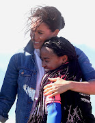  Meghan, Duchess of Sussex, hugs a surf mentor as she visits the NGO Waves For Change at Monwabisi Beach, on September 24 2019 in Cape Town. 