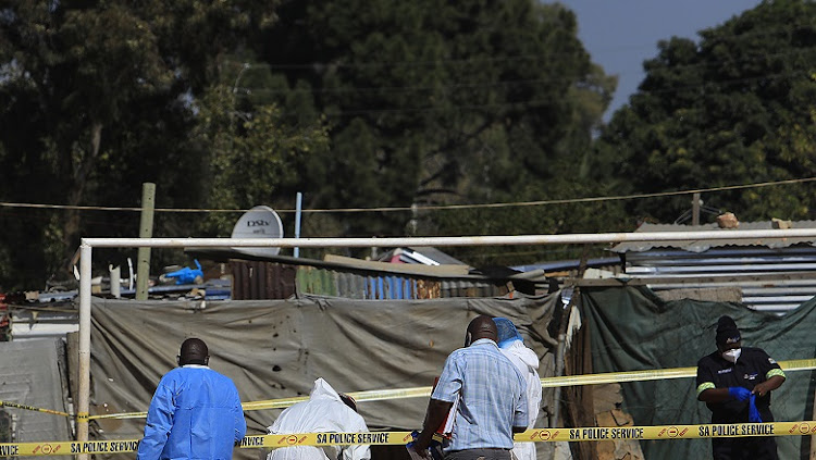 Police comb through the crime scene for evidence after the attack on nine youths in Zandspruit early on Wednesday.