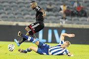 STUDS UP: Mpho Makola of Orlando Pirates and Maritzburg United's Michael Morton let their feet do the talking during their sides' Absa Premiership match at Orlando Stadium, Soweto, last night