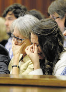 SHARED PAIN: Aimee Pistorius, right, sister of murder accused athlete Oscar Pistorius, listens to his emotional testimony in the Pretoria High Court yesterday