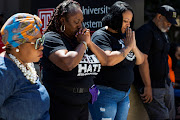 Dr. Deshawnda Williams (2L) prays alongside community members at an anti-gun violence rally held in Philadelphia, Pennsylvania, U.S., June 4, 2022.  