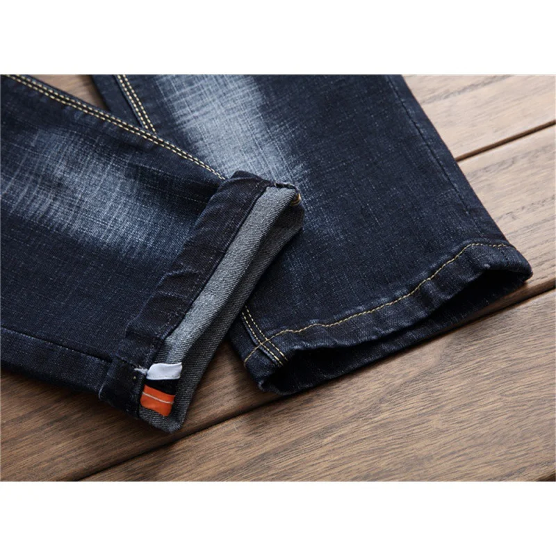 Niebieskie jeansy męskie z dziurami, slim fit i proste nogawki. Stylowe i wygodne. Idealne do codziennych, modnych stylizacji.