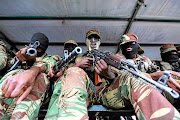 Zimbabwe military troops stand guard during November 2017 negotiations to remove Robert Mugabe as the country's president. It emerged this week that military officials warned that a fight-back by Mugabe would have resulted in bloodshed.