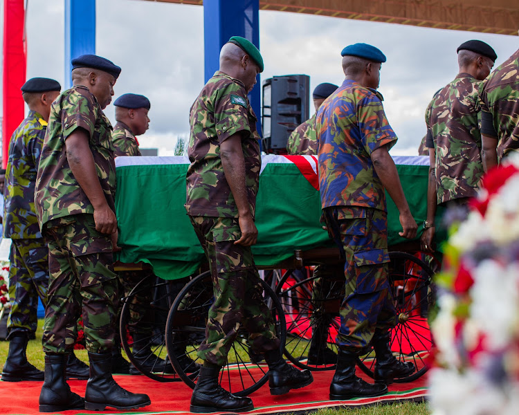 Military officers carry the casket bearing the remains of late General Francis Ogolla at Ulinzi sport complex on April 20, 2024.