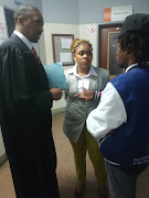 Sibongile Mani gets instructions from her lawyer Asanda Pakade, left.