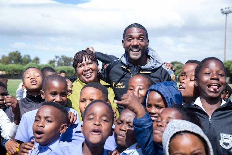 Olympic sprinter Justin Gatlin with kids in Langa, Cape Town, where he and former American hurdles record holder, Sharrieffa Barksdale, were promoting their athletic development organisation Born 2 Be Elite.