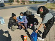 Casey van Wyk handing out food parcels to the homeless in Johannesburg. 