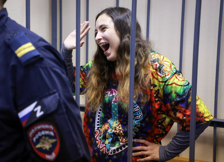 Alexandra (Sasha) Skochilenko, a 33-year-old artist and musician charged with spreading false information about Russia's armed forces after replacing supermarket price tags with slogans protesting against the country's military operation in Ukraine, reacts inside an enclosure for defendants during a court hearing in Saint Petersburg, Russia November 8, 2023.