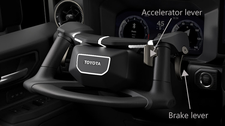 Instead of pedals, throttle and braking functions are controlled by levers on the steering wheel.