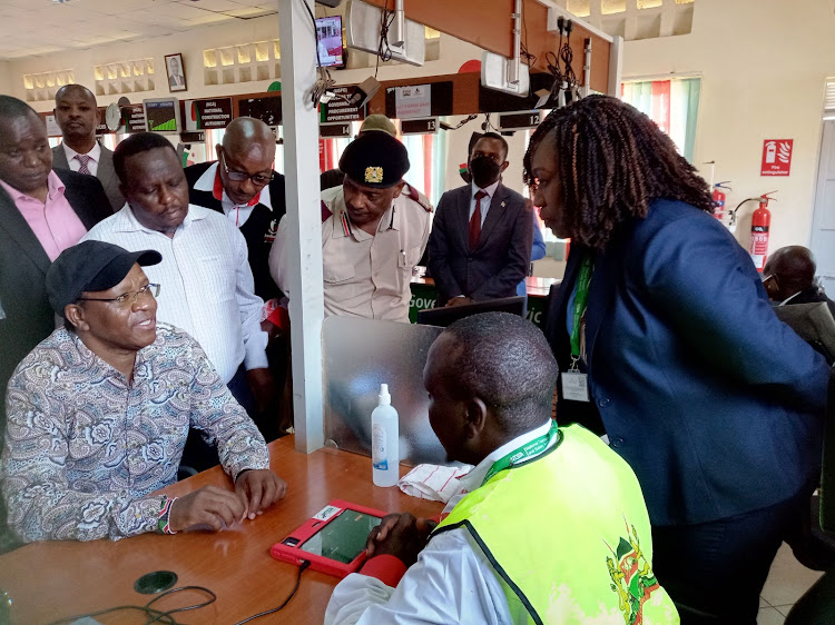 Kerugoya huduma centre NTSA officials explain to Interior PS Karanja Kibicho about the bodaboda registration which was officially launched on Monday