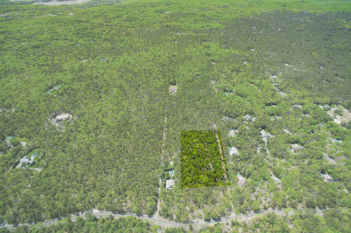 Wooded lot with surrounding development in this luxury land for sale in East Hampton ($2,795,000 - 12,950 m²)