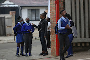 Temperatures are checked at Tlhatlogang Junior Secondary School, in Mofolo Central, Soweto, on the first day of school.