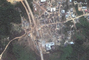 A satellite image shows the damages in Apiate, Ghana January 22, 2022, two days after a vehicle carrying mining explosives detonated along a road.  