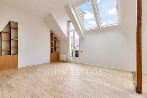 Attic room with wall shelves in this luxury property for sale in Paris 6ème ($1,459,735 - 64 m²)
