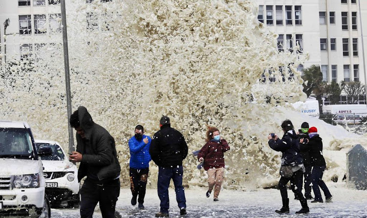 The cold front brought gale force winds, rough seas and sea foam which happens when large blooms of algae decay offshore and are agitated by wind and waves to the shores of Sea Point promenade in Cape Town on July 13 2020.