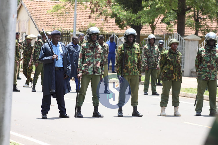 Police officers form layers of barriers to beef up security along the road leading to Kisumu State Lodge awaiting Azimio La Umoja protesters on March 17, 2023