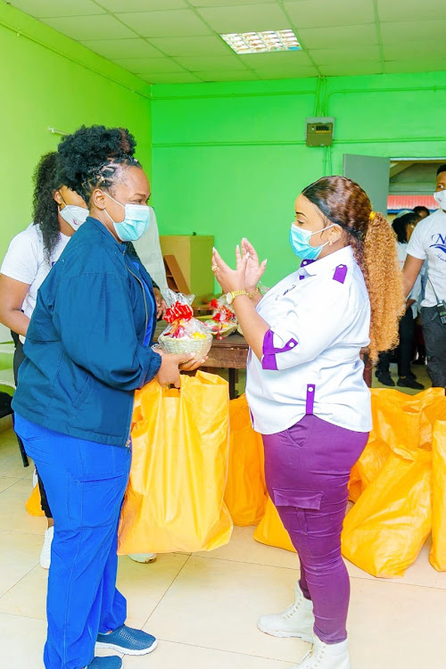 Rev Natasha hands out the supplies.