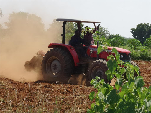 A tractor ploughs in preparation for planting. 1,000 tractors will be availed to farmers in various parts of the country through a tractor distribution scheme