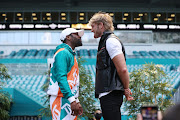 Floyd Mayweather and Logan Paul face off during media availability prior to their June 6 match at Hard Rock Stadium on May 06, 2021 in Miami Gardens, Florida. 