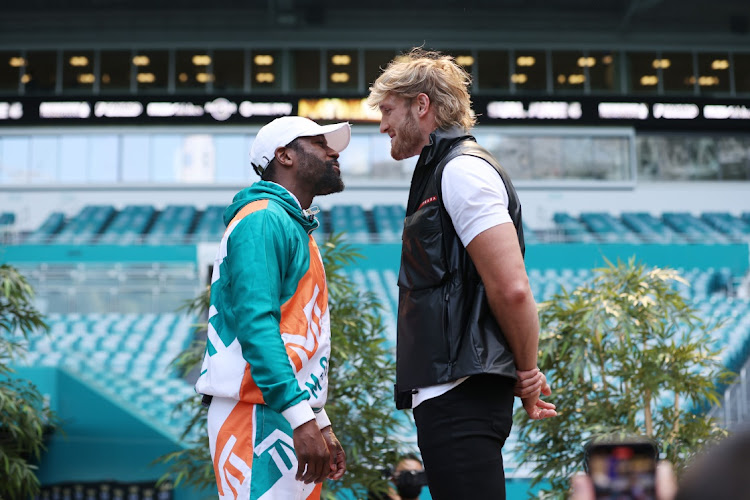 Floyd Mayweather and Logan Paul face off during media availability prior to their June 6 match at Hard Rock Stadium on May 06, 2021 in Miami Gardens, Florida.