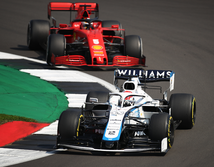 Williams' George Russell and Ferrari's Sebastian Vettel in action during the race Pool via REUTERS/Bryn Lennon