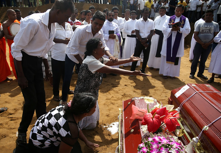 Women react during a mass burial of victims, two days after a string of suicide bomb attacks on churches and luxury hotels across the island on Easter Sunday, at a cemetery near St. Sebastian Church in Negombo, Sri Lanka April 23, 2019. TPX IMAGES OF THE DAY