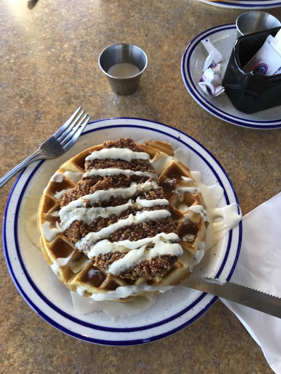 Chicken and waffle with lemon basil sauce and maple syrup