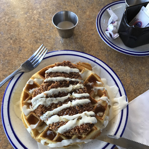 Chicken and waffle with lemon basil sauce and maple syrup