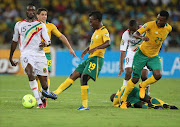 Bafana Bafana's May Mahlangu, Siyabonga Sangweni and Dean Furman fighting for possession against Mali's Samassa Mahamadou and Sow Samba during the  Afcon quarter final match at Moses Mabhida stadium in Durban yesterday. Pic: 02/02/2013. © Sunday Times