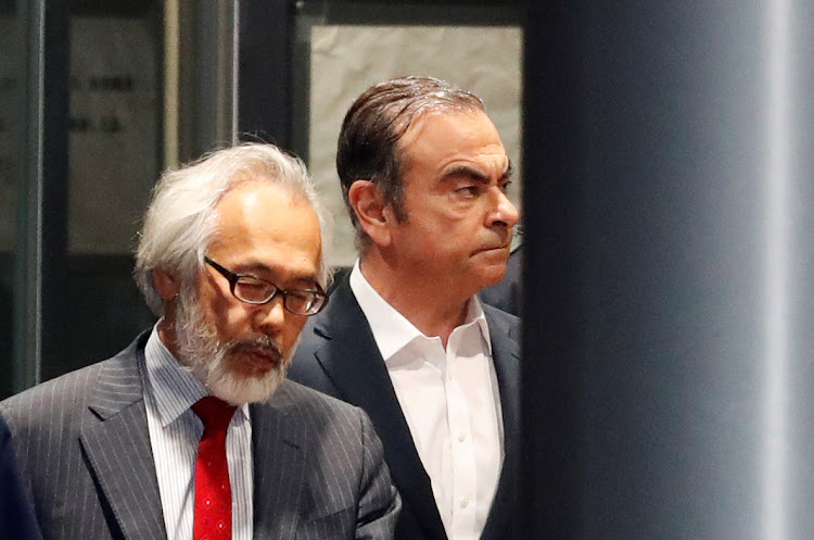 Former Nissan chariman Carlos Ghosn, right, leaves the Tokyo Detention House in Japan on April 25 2019.