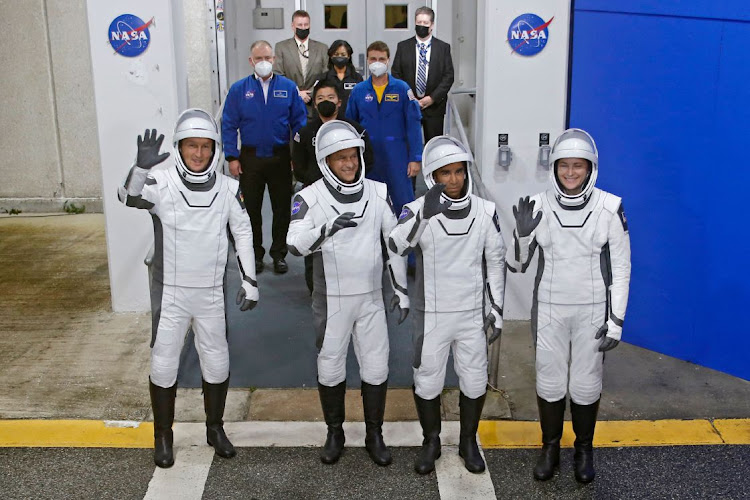 European Space Agency (ESA) astronaut Matthias Maurer of Germany, NASA astronauts Raja Chari, Tom Marshburn, and Kayla Barron wave while departing the crew quarters for launch aboard a SpaceX Falcon 9 rocket on a mission to the International Space Station at the Kennedy Space Center in Cape Canaveral, Florida, US, on November 10, 2021.