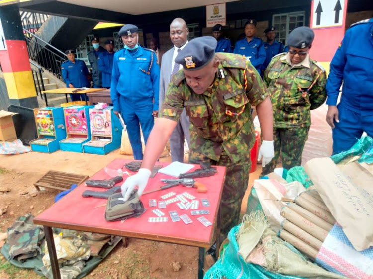 County commander Perminus Muchangi shows some of the weapons they recovered from the suspects.