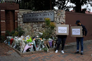 People picket outside Parktown Boys High, where classes resumed on Tuesday morning following a day of counselling for those affected by the death of pupil Enock Mpianzi.