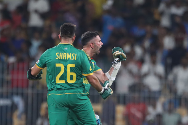 Keshav Maharaj and Tabraiz Shamsi of South Africa celebrate their victory over Pakistan during the 2023 Cricket World Cup match at MA Chidambaram Stadium.