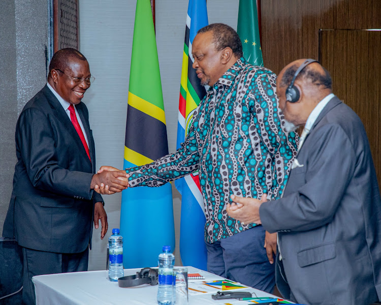 Former President Uhuru Kenyatta greeting dignitaries during the 1st International Colloquium in Tanzania on February 20,2024.