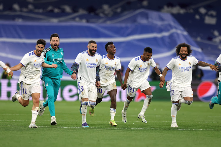 Real Madrid players celebrate following the final whistle of the Uefa Champions League semifinal second leg against Manchester City at Estadio Santiago Bernabeu in Madrid on May 4 2022.