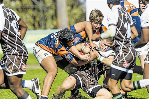 KEEPIN A TIGHT GRIP: Bruce Graig of Border tries to hold on to the ball while GWK Griquas Rural players do their best to wrench it from him in their clash at the U18 Coca-Cola Academy Week at Kearsney College in Durban yesterday Picture: GALLO IMAGES