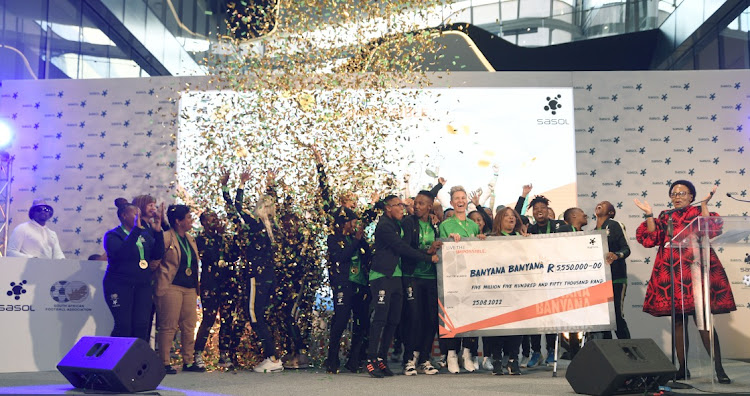 Charlotte Mokoena, right, of sponsors SASOL presents Banyana Banyana with a cheque for R5.5m during an event to honour the team at the petroleum giant's headquarters last week. In total Banyana have received R29.5m in bonuses.