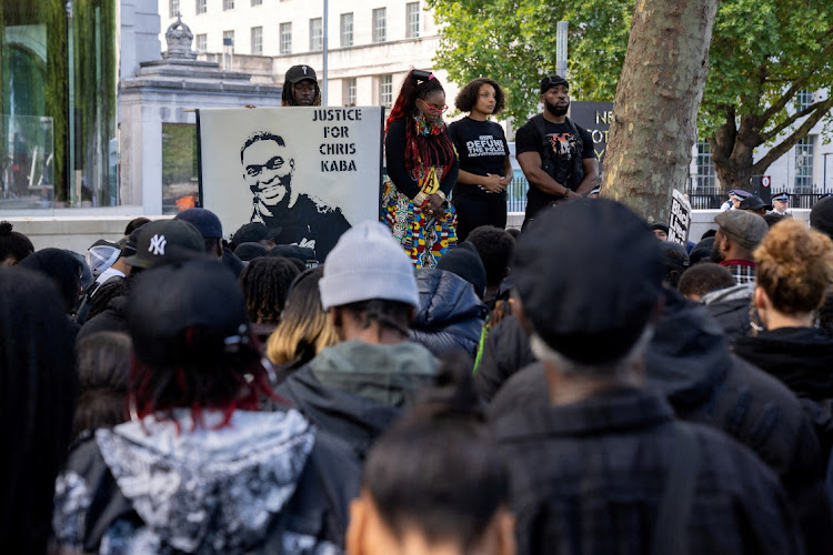 Black Lives Matter protesters observe a minute of silence in front of New Scotland Yard building in central London, demanding justice for Chris Kaba.