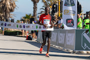 Stephen Mokoka crosses the finishing line first at the Nedbank Runified Breaking Barriers race in Gqeberha.