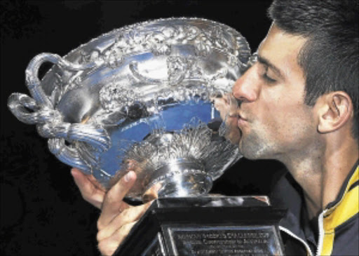 SWEET HAT-TRICK: Novak Djokovic kisses the Norman Brookes Challenge Cup after defeating Andy Murray in their men's singles final match at the Australian Open yesterday.Photo: REUTERS