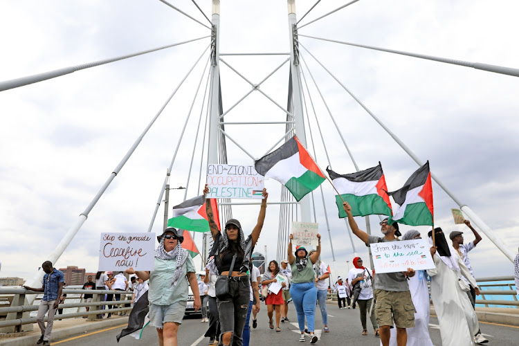 Demonstrators march through the streets of downtown Joburg on November 29 2023 in solidarity with the people of Palestine.