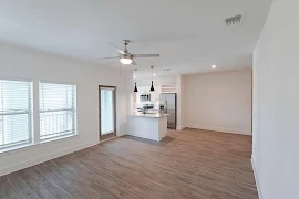 Open living areas with large windows full of natural light. Wood inspired flooring throughout. Patio/balcony door.