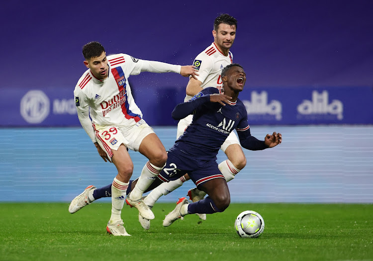 Olympique Lyonnais' Bruno Guimaraes in action with Paris St Germain's Nuno Mendes