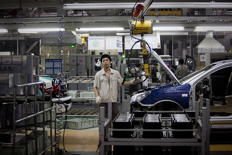 Employees at the final inspection line at the Beijing Automotive Industry Holding Co Ltd and Hyundai Motor Co factory in Beijing, China.