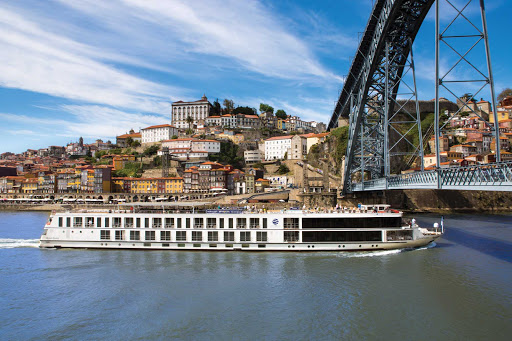 Uniworld's Queen Isabel passes beneath a bridge on the Douro River. 