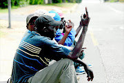 TOUGH TIMES: Jobless men looking for piece jobs  at a street corner in  Meredale, Joburg. The writer says job loss can bring about a combination of feelings - it can be a traumatic, scary and infuriating experience Photo: Katherine Muick