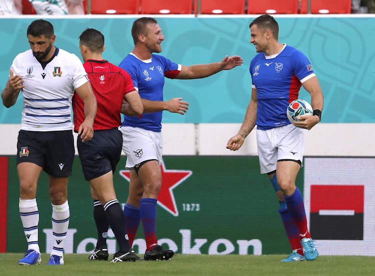 Namibia’s JC Greyling celebrates with team mate after scoring their second try during the Rugby World Cup Pool B match against Italy in Osaka.